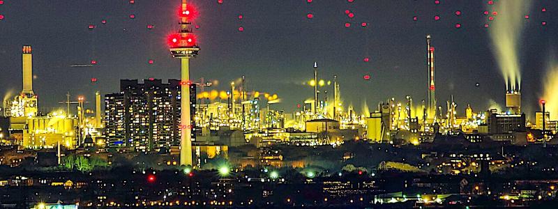 Telekommunikationstornet i Mannheim, med de tre höghusen vid floden Neckar. 18 kilometer bakom syns de röda varningsljusen från vindkraftverk vid Großniedesheim i Rheinland-Pfalz (vid god sikt från Heidelberg). Foto: Wikipedia Common, kredit: Georg Buzin